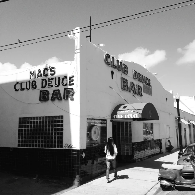 a black and white po shows the front of a bar