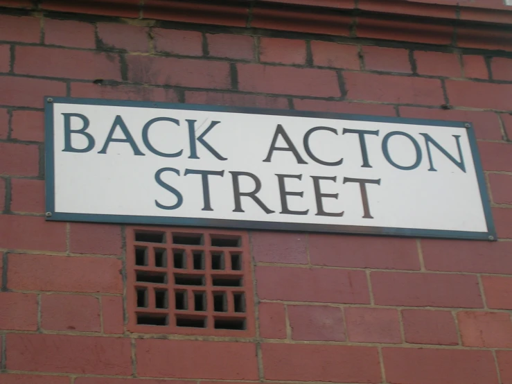 street name sign placed on red brick building