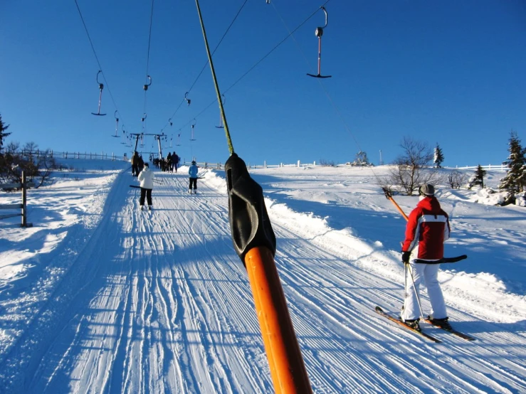 a man riding skis down the side of a snow covered slope