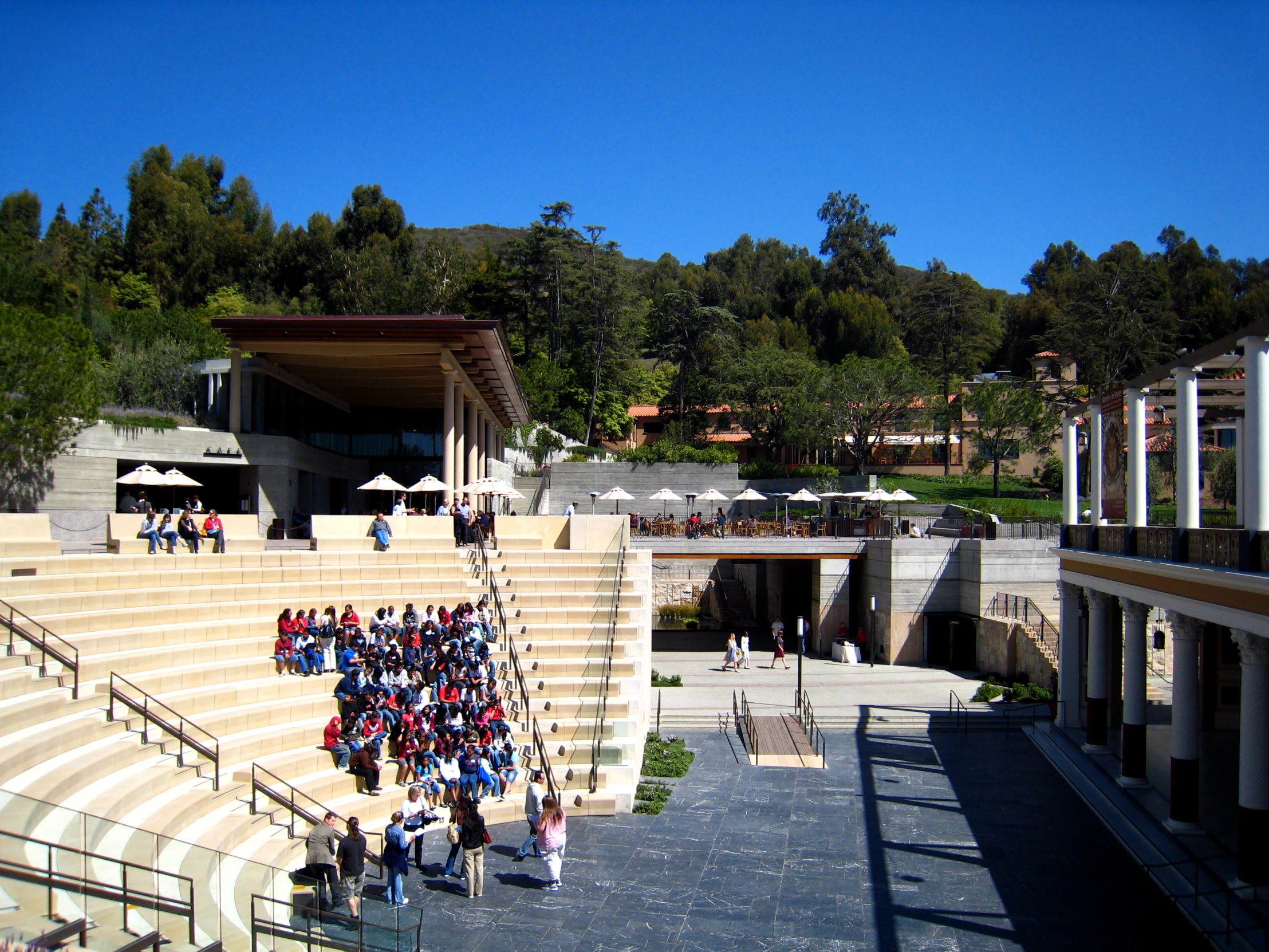 an auditorium with people standing outside on the upper level