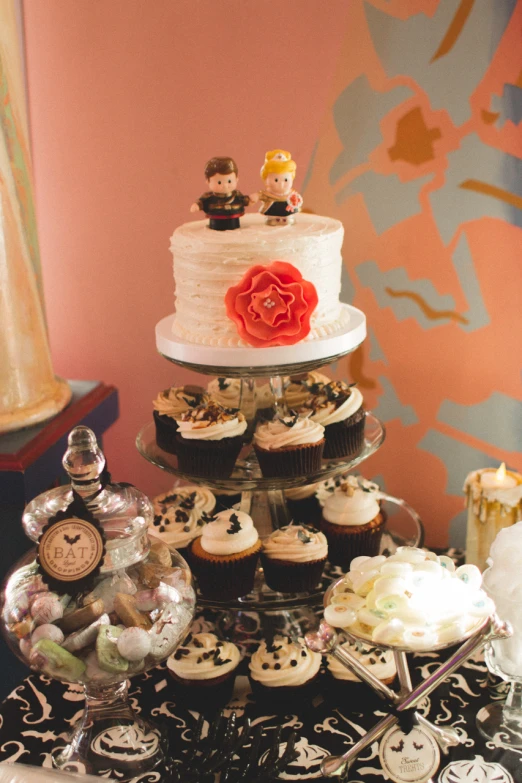 a large table with cup cakes and decorated candies