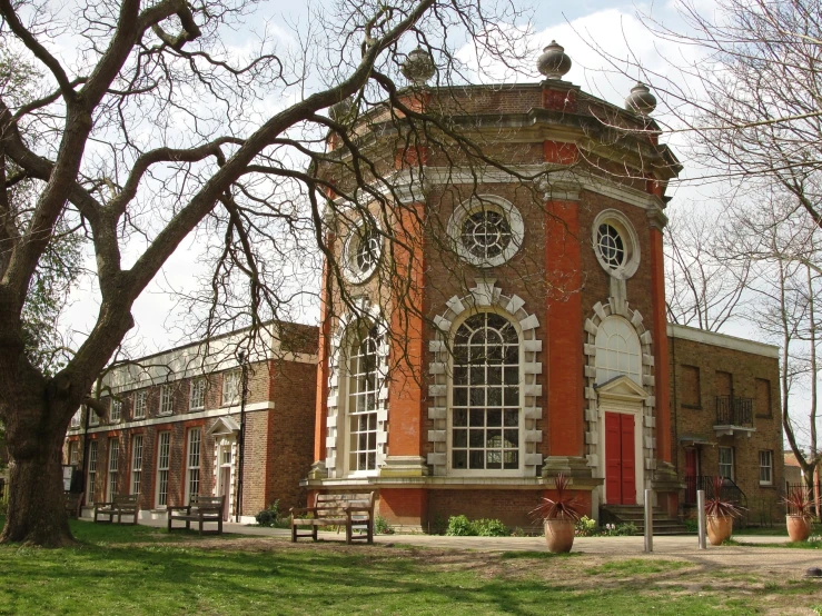 a red and white building has trees in front