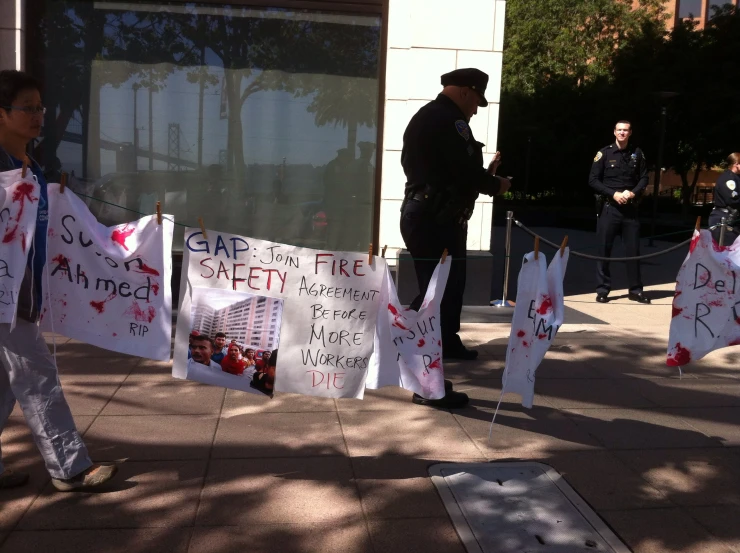 a group of protesters hold signs and demonstrate an order