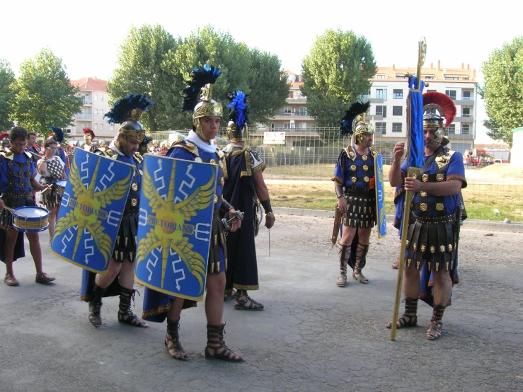 a group of men in costume carrying large items on them