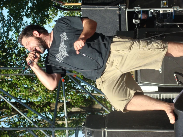 a man is singing into a microphone and standing on the stage