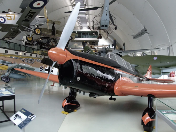 an old propeller airplane in a museum that looks like it has had the number eight