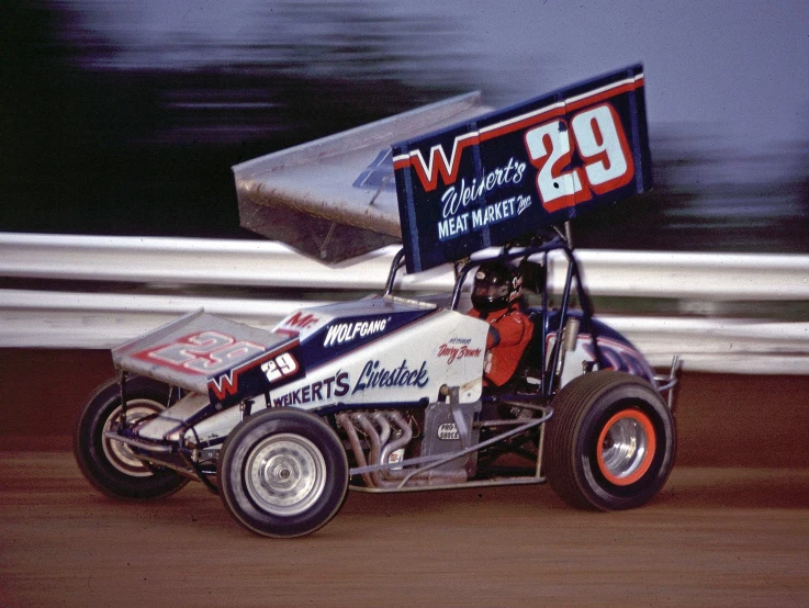 a person in an dirt buggy drives down a track