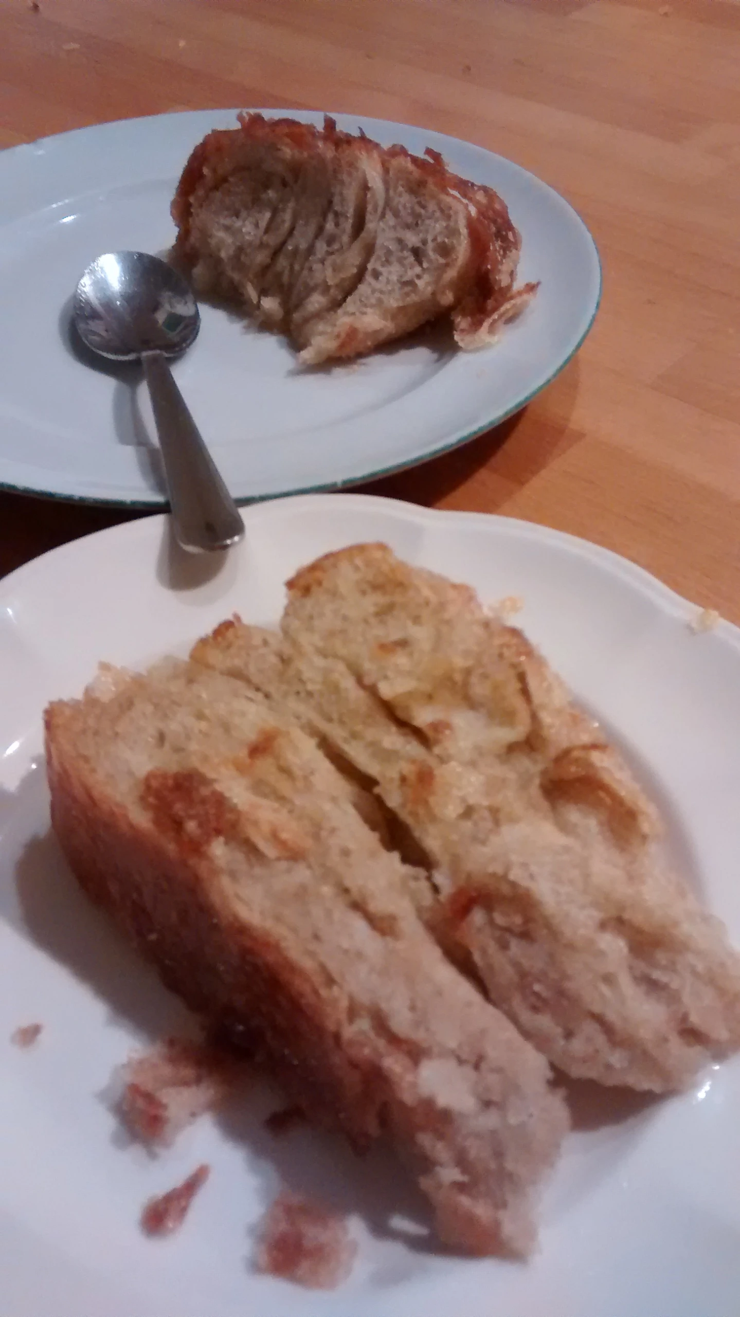 two plates with slices of bread and a spoon on them