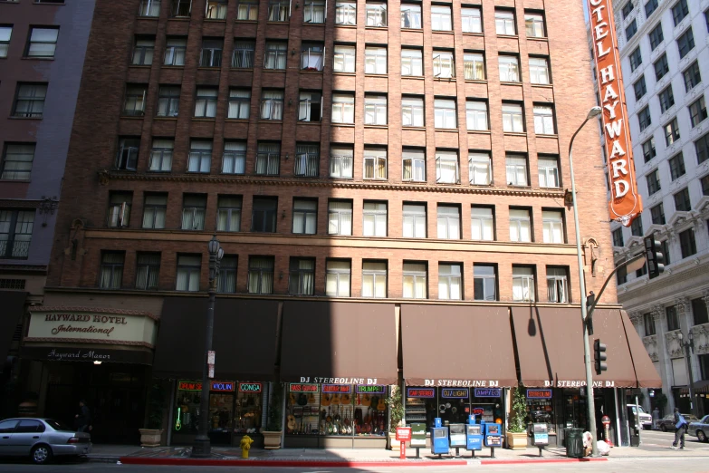 a tall building near a red brick street with cars