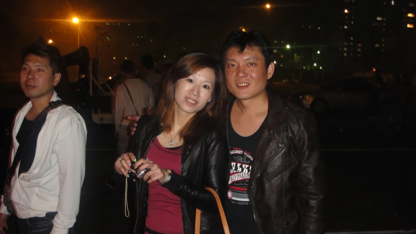 a young couple pose for the camera at a bar