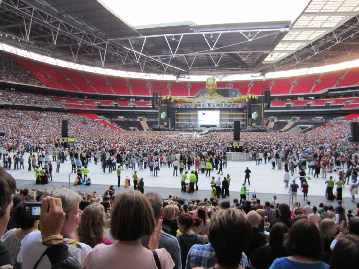 a big stadium filled with people and a lot of bright red chairs