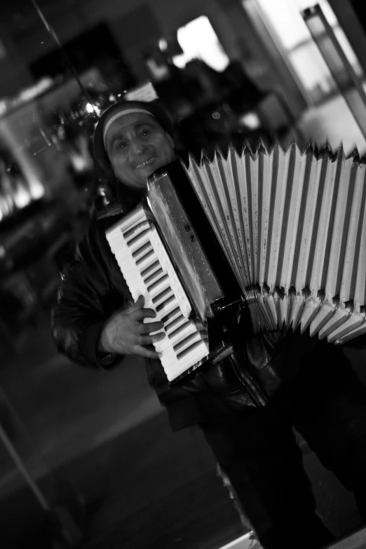 the man is holding an accordion in his hands