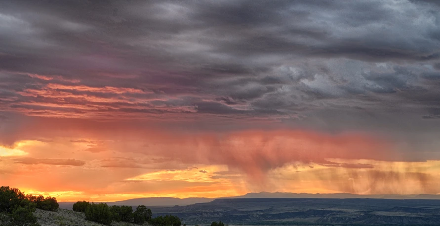 a cloudy sunset with light streaks of sunlight coming from behind