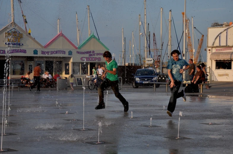 the boys are playing outside playing in the water