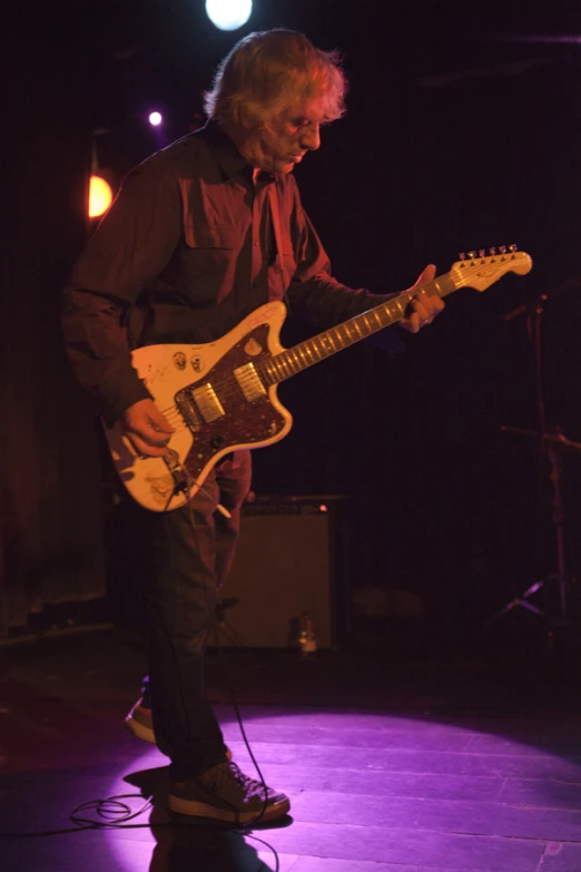 a man plays the guitar at a concert