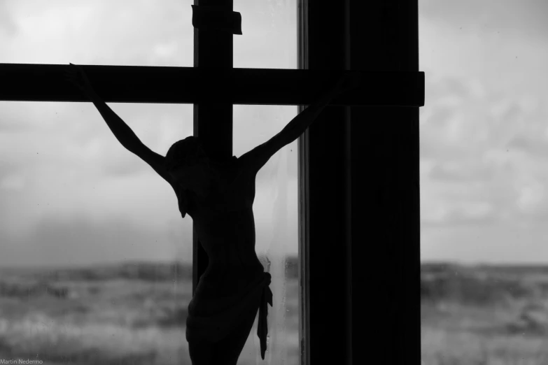 a person that is on the cross by the window