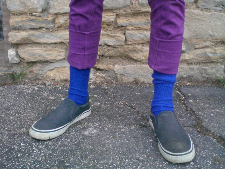 a close up of the legs of a person wearing purple pants
