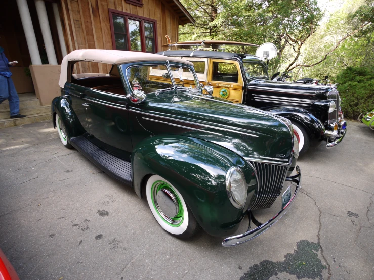 a group of old fashion cars are parked in the street