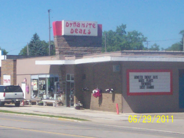 a store front next to a road with traffic