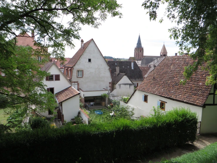 the rooftops of many old buildings are tan with red roofs