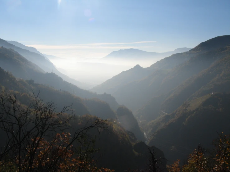 the sun shines on some mountains in this beautiful valley