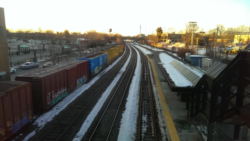 several train tracks running side by side with many snow - covered tracks