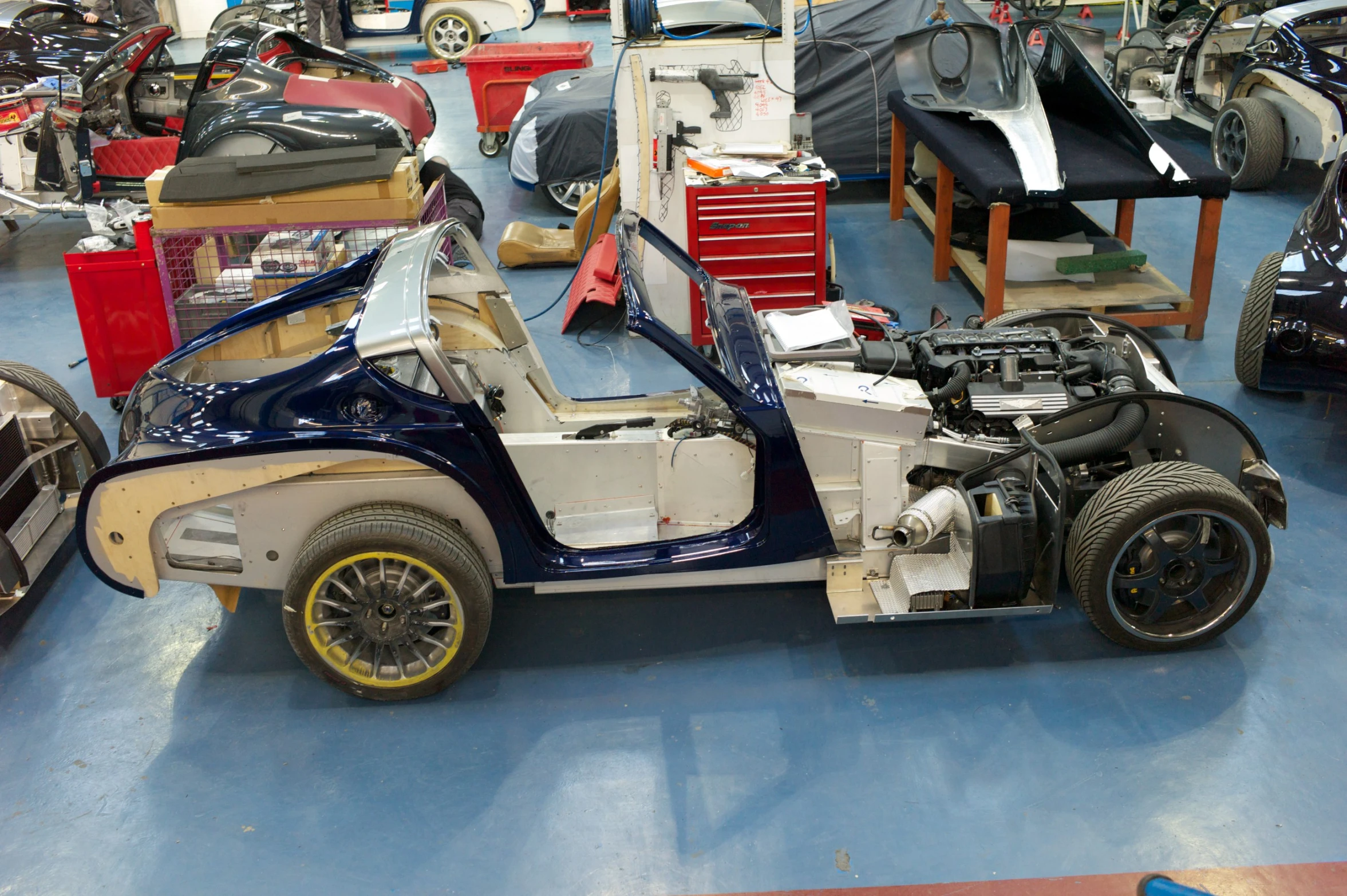 a variety of different types of cars parked in a garage