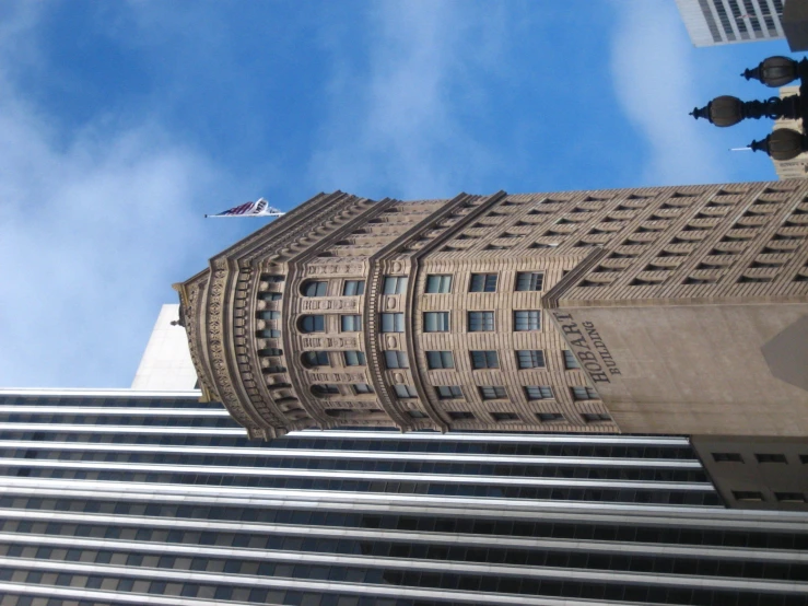 an upward view of some skyscrs on a clear day