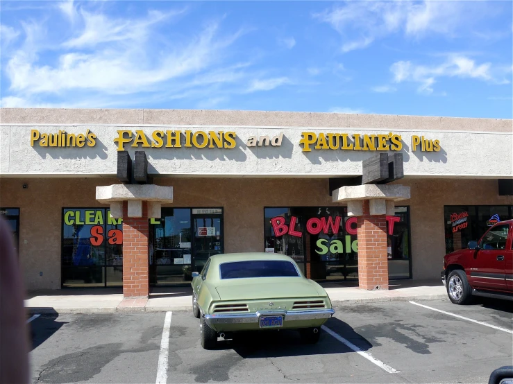 a car is parked in a parking lot next to the doors of a building