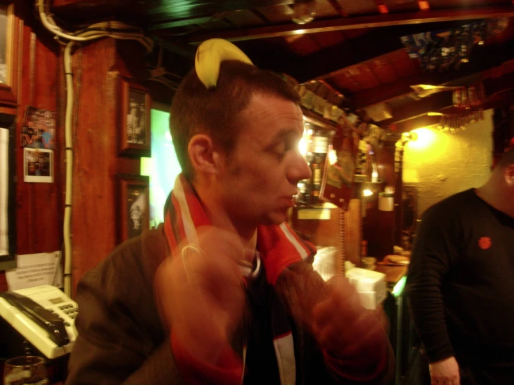 two men are sitting down and having fun in the pub