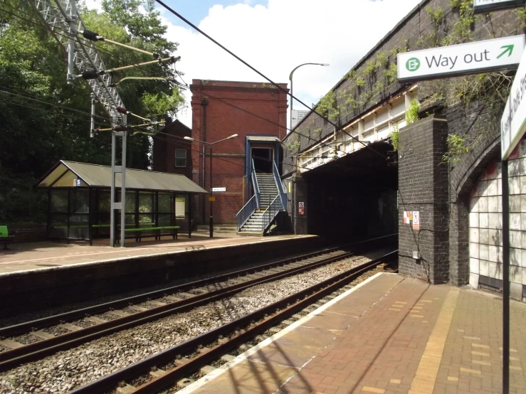 the train tracks outside a station with brick walls