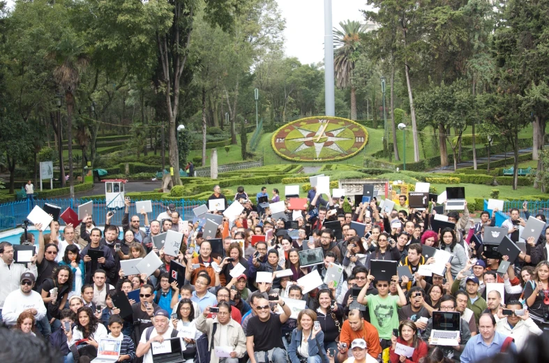 a group of people standing outside holding up signs