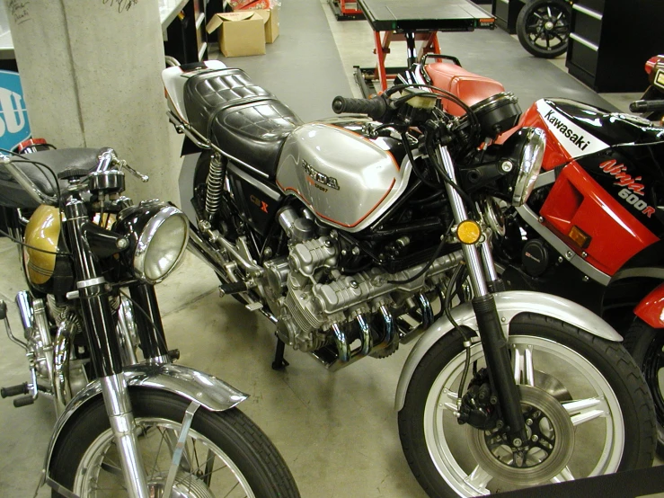 two motorcycle parked next to each other in a garage