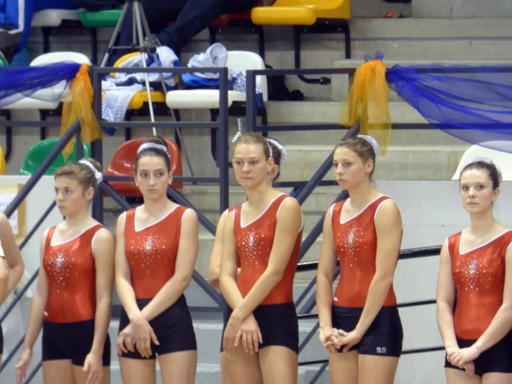 a group of women on gymnastics standing next to each other