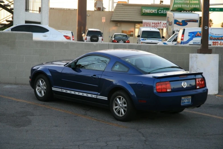 a blue mustang parked in the parking lot