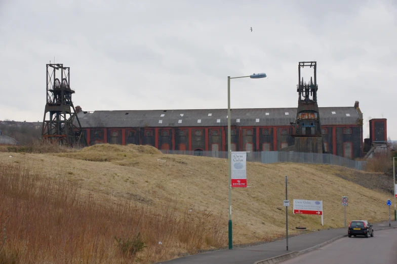 an old industrial building on the corner of a road