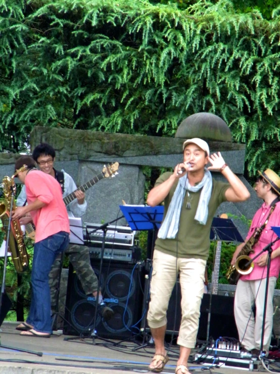 a man singing into a microphone next to music