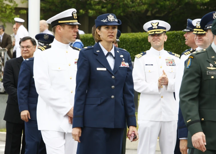 several military officers standing near each other with people in uniform