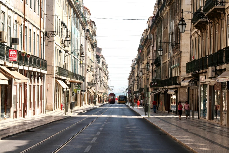 people walk on a quiet street in the city