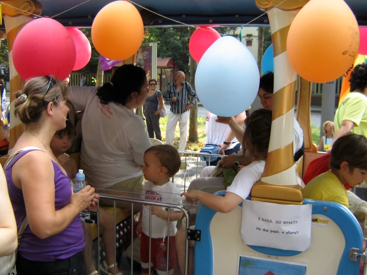 a group of people gathered around and looking at the children