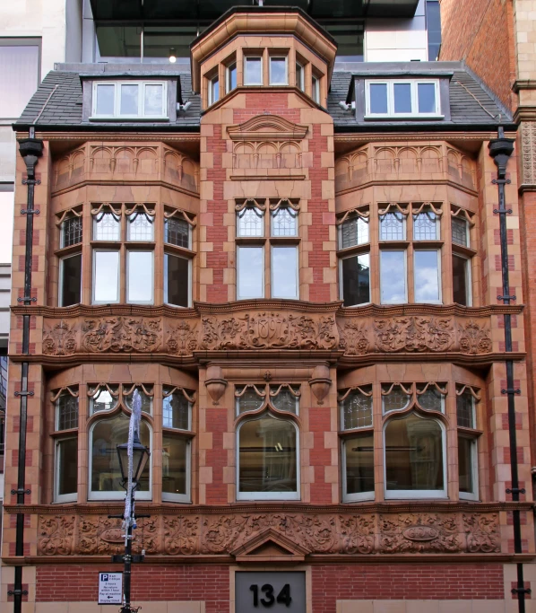 a tall building with many windows and a clock