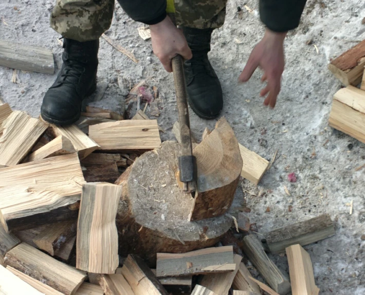 a man chopping logs with an axe