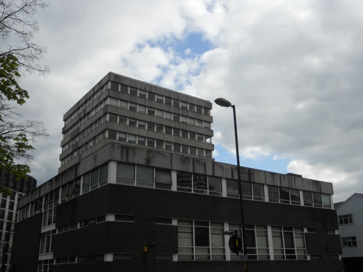 a tall building sits near a traffic signal