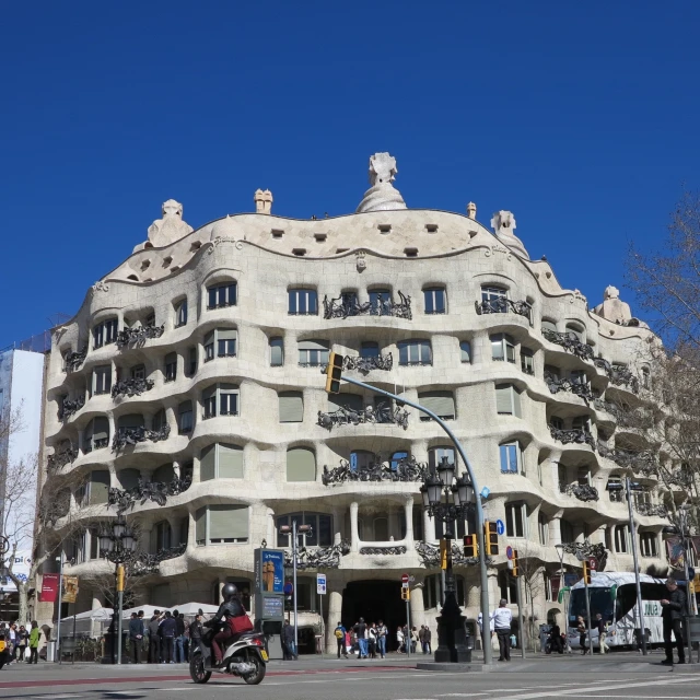 people on motorcycles outside a building with balconies