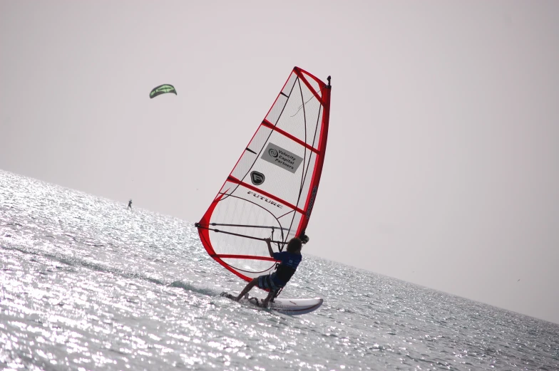 a wind surfer is in the middle of a sail