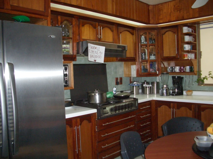 the kitchen has cabinets, a stove and a refrigerator