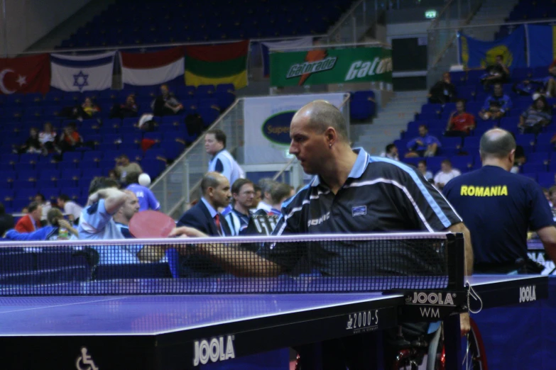 a man holds his arm out as he is about to serve