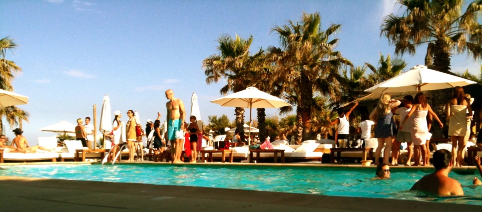 people in a pool having a party on a clear day