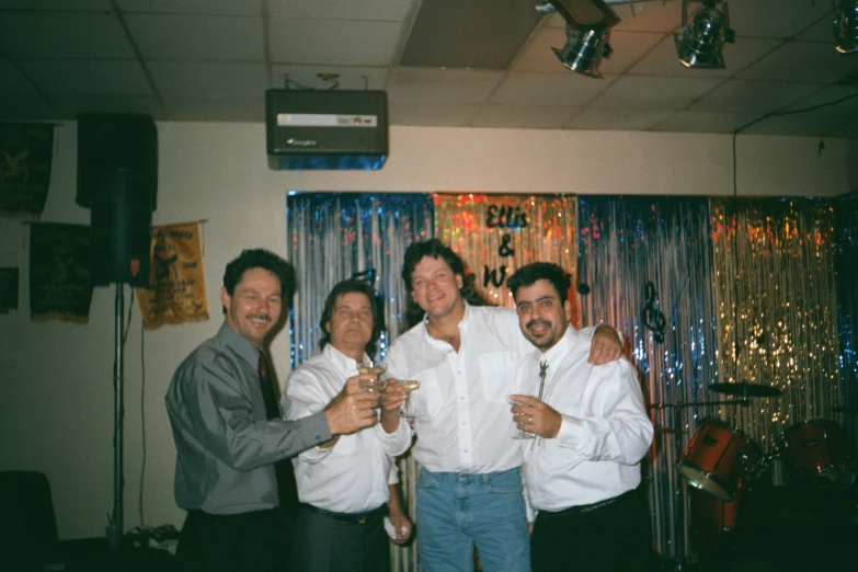 some guys posing for a po with champagne