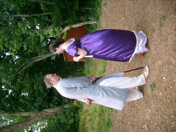 a couple of people in a field standing next to each other